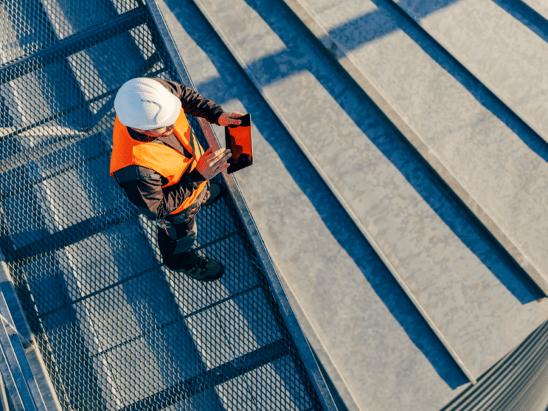 Man performing inspection on an industrial roof