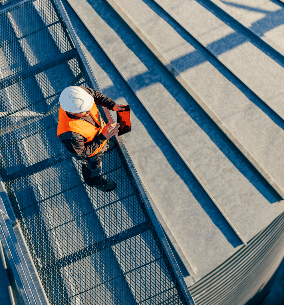 Man performing inspection on an industrial roof